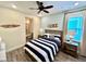 Nautical themed bedroom is equipped with a full bathroom, ceiling fan and window at 3083 Pirate Way, Kissimmee, FL 34747