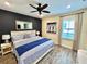 Comfortable bedroom boasts a stylish accent wall and soothing wood-look tile floors at 3083 Pirate Way, Kissimmee, FL 34747