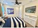 Stylish bedroom with coastal decor, television, and built-in storage at 3083 Pirate Way, Kissimmee, FL 34747