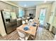 Cozy dining area with gray cabinets, stainless steel appliances, and a rustic wooden table at 3083 Pirate Way, Kissimmee, FL 34747