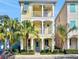 Charming two-story home with balconies, yellow siding, and lush landscaping, perfect for coastal living at 3083 Pirate Way, Kissimmee, FL 34747