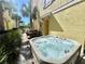 Inviting hot tub on a private patio, set amidst lush landscaping and outdoor dining area at 3083 Pirate Way, Kissimmee, FL 34747
