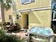 Relaxing hot tub with outdoor dining set against yellow home exterior, perfect for entertaining at 3083 Pirate Way, Kissimmee, FL 34747