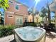 Backyard with Hot Tub surrounded by tropical landscaping and a patio dining area at 3083 Pirate Way, Kissimmee, FL 34747