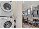 Convenient laundry area with stacked washer and dryer, adjacent to the dining room at 3083 Pirate Way, Kissimmee, FL 34747
