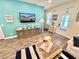 Inviting living room featuring stylish decor, a large flat-screen TV, and a cozy seating area at 3083 Pirate Way, Kissimmee, FL 34747