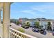 Balcony view showcases a colorful residential street with ample parking and tropical landscaping at 3083 Pirate Way, Kissimmee, FL 34747