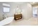 Bright bathroom featuring a freestanding tub, a vanity, and modern fixtures at 319 Arbor Pointe Ave, Minneola, FL 34715