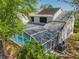 Aerial view of a home showcasing a screened-in pool, mature trees and solar panels on the roof at 358 Morning Creek Cir, Apopka, FL 32712