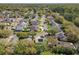 Wide aerial view of a residential neighborhood with lush landscaping, homes, and quiet streets at 358 Morning Creek Cir, Apopka, FL 32712