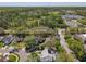 An aerial view showing the property and surrounding area with lush greenery and neighborhood streets at 358 Morning Creek Cir, Apopka, FL 32712