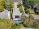 Aerial view of a home with a fenced backyard, screened-in pool and solar panels on the roof at 358 Morning Creek Cir, Apopka, FL 32712