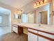 Bathroom featuring double sinks, a large mirror, and ample counter space at 358 Morning Creek Cir, Apopka, FL 32712