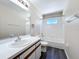 Bright bathroom with a vanity, mirror, and a tub-shower combo with white tile at 358 Morning Creek Cir, Apopka, FL 32712