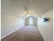 Carpeted bedroom featuring a ceiling fan, arch window, and wall-mounted TV bracket at 358 Morning Creek Cir, Apopka, FL 32712