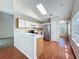 Bright kitchen features stainless steel appliances, white cabinets, and wood-look floors at 358 Morning Creek Cir, Apopka, FL 32712
