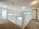 Carpeted landing area with white railing at 358 Morning Creek Cir, Apopka, FL 32712