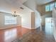 Bright living room featuring hardwood floors with pool view and a modern light fixture at 358 Morning Creek Cir, Apopka, FL 32712