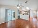 Open living room with wood-look floors and sliding doors leading to outdoor space at 358 Morning Creek Cir, Apopka, FL 32712