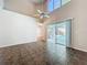 Spacious living room showcasing ceramic tile floors and sliding door access to the pool at 358 Morning Creek Cir, Apopka, FL 32712