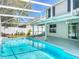 Screened-in outdoor pool with a view of the home's exterior and surrounding landscaping at 358 Morning Creek Cir, Apopka, FL 32712