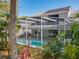 Beautiful screened-in pool surrounded by lush landscaping, creating a private and serene outdoor oasis at 358 Morning Creek Cir, Apopka, FL 32712