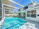 Inviting screened-in pool area with crystal clear water and ample patio space, perfect for relaxing and entertaining outdoors at 358 Morning Creek Cir, Apopka, FL 32712