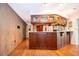 Dark wood kitchen bar with glass display shelves, perfect for entertaining guests at 381 Maple Ct, Oviedo, FL 32765