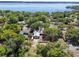 Ariel view showcases this home's mature tree coverage, ample parking, and proximity to a nearby lake at 392 W Minnehaha Ave, Clermont, FL 34711