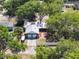 An aerial view of this home that showcases mature tree coverage and ample parking near the two car garage at 392 W Minnehaha Ave, Clermont, FL 34711