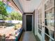 Inviting back porch with tiled floor, garden decor, and a view of the lush backyard at 392 W Minnehaha Ave, Clermont, FL 34711