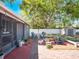 Expansive backyard featuring mature trees, outdoor seating area, storage shed, and privacy fence at 392 W Minnehaha Ave, Clermont, FL 34711