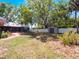 Extensive backyard featuring a storage shed, white fence line, and mature landscaping at 392 W Minnehaha Ave, Clermont, FL 34711