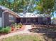 The backyard features a brick patio and walkway, lush landscaping, seating area, and storage shed at 392 W Minnehaha Ave, Clermont, FL 34711