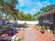 Spacious backyard with a storage shed, white fence, seating area, and mature landscaping at 392 W Minnehaha Ave, Clermont, FL 34711