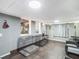 Well-lit finished basement featuring tile floors, a kitchen view, and pet kennel areas at 392 W Minnehaha Ave, Clermont, FL 34711