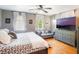 Bedroom featuring modern gray walls, hardwood floors, and lots of natural light plus a relaxing entertainment area at 392 W Minnehaha Ave, Clermont, FL 34711