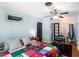 Light and airy bedroom with pale blue walls, a bed with a colorful quilt, and a ceiling fan at 392 W Minnehaha Ave, Clermont, FL 34711