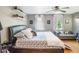 Bright bedroom features modern gray walls, hardwood floors, and lots of natural light and a comfortable seating area at 392 W Minnehaha Ave, Clermont, FL 34711
