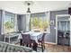 Bright dining area features modern gray walls, wood floors, lots of light and a stylish table and seating arrangement at 392 W Minnehaha Ave, Clermont, FL 34711