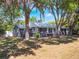 Lovely home framed by mature trees, with a well-manicured lawn and welcoming front exterior at 392 W Minnehaha Ave, Clermont, FL 34711