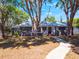 Charming home featuring mature trees, a walkway, and a neatly maintained front yard at 392 W Minnehaha Ave, Clermont, FL 34711