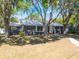 Classic home with mature trees offering shade, complemented by a well-kept lawn and front walkway at 392 W Minnehaha Ave, Clermont, FL 34711