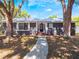 Inviting home featuring a walkway, tidy landscaping, and a freshly painted exterior at 392 W Minnehaha Ave, Clermont, FL 34711