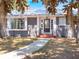 Charming exterior with well-kept lawn, mature trees, and a clear view of the home's facade at 392 W Minnehaha Ave, Clermont, FL 34711