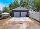 Detached two-car garage with a concrete driveway and boat parked on the side at 392 W Minnehaha Ave, Clermont, FL 34711