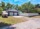 Features a detached two-car garage with an extra parking pad in front, and boat on the side at 392 W Minnehaha Ave, Clermont, FL 34711
