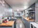 Modern kitchen with gray cabinets, wood counters, stainless appliances, stylish backsplash, and lots of storage at 392 W Minnehaha Ave, Clermont, FL 34711