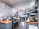 Well lit kitchen area with stainless steel appliances, gray shaker cabinets, butcher block countertops, and modern fixtures at 392 W Minnehaha Ave, Clermont, FL 34711