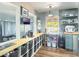 Modern kitchen with open storage, shaker cabinets, butcher block countertops, and stainless appliances and fixtures at 392 W Minnehaha Ave, Clermont, FL 34711
